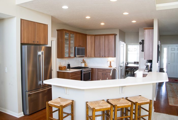 warm wood cabinets with white countertops before and after kitchen remodel how does cabinet refacing work